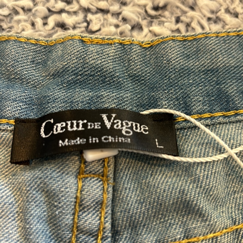 Large light blue soft denim cuffed jean shorts with shredded holes. - Picture 2 of 4